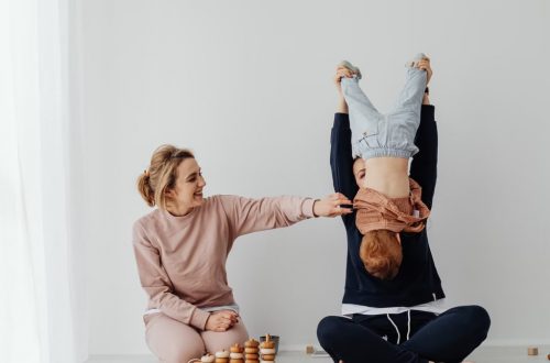 Mother and child enjoying playful time indoors with educational toys.